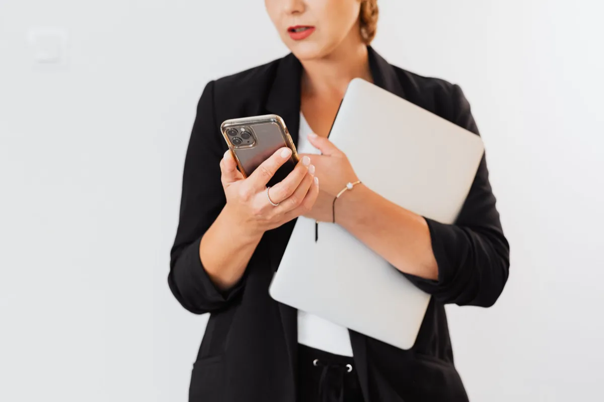 Mulher de negócios brasileira usando smartphone no escritório